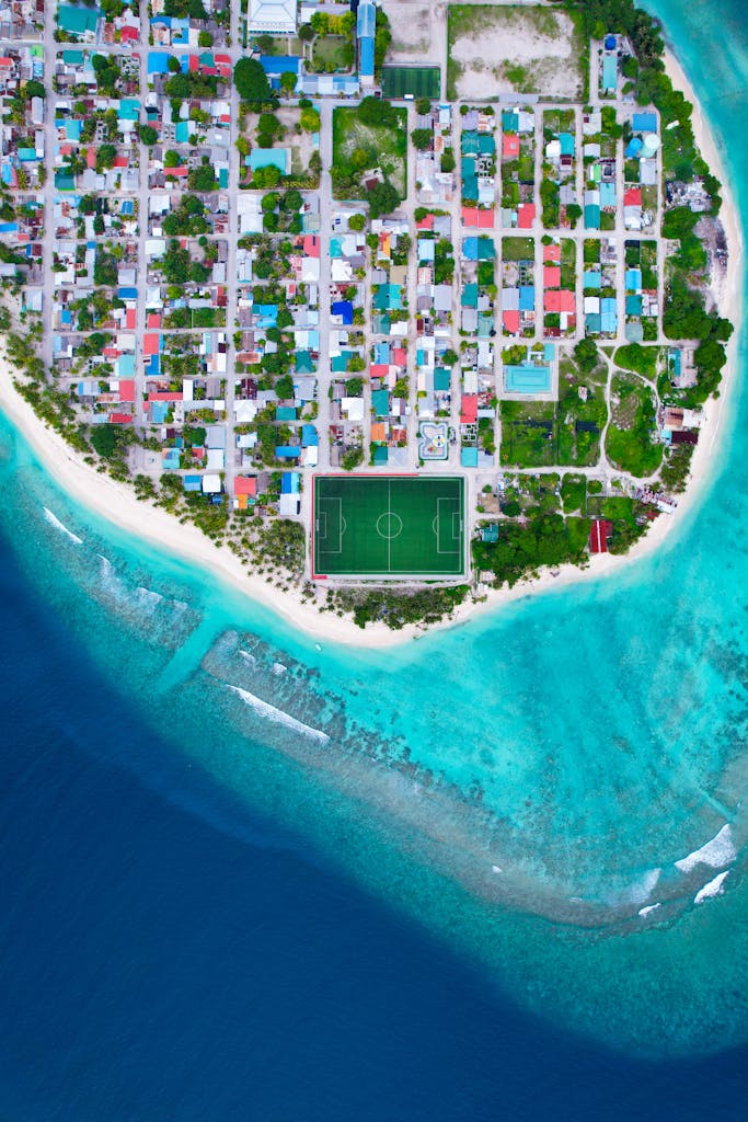 Stunning aerial shot of Meedhoo, Raa Atoll in Maldives showcasing turquoise waters and urban layout.
